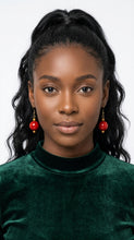 Load image into Gallery viewer, Woman wearing Sasha L Jewels red earrings and a green sweater 
