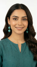Load image into Gallery viewer, Woman wearing a teal embroidered top with matching Sasha L Jewels Double Cotton Thread earrings 