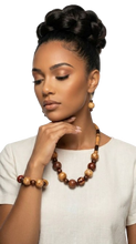 Load image into Gallery viewer, Tribal Handmade Jewelry. Woman wearing a wooden necklace and earrings against a white background