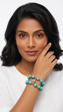 Load image into Gallery viewer, Woman wearing a turquoise beaded Sasha L Jewels bracelet on a white background