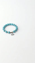 Load image into Gallery viewer, Turquoise beaded bracelet with a small lotus charm. Sasha L Jewels Designer