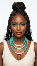 Load image into Gallery viewer, Woman with braided hair wearing a Sasha L Jewels turquoise necklace and white top 